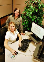 Two female Mountain Software support team members at computer monitor